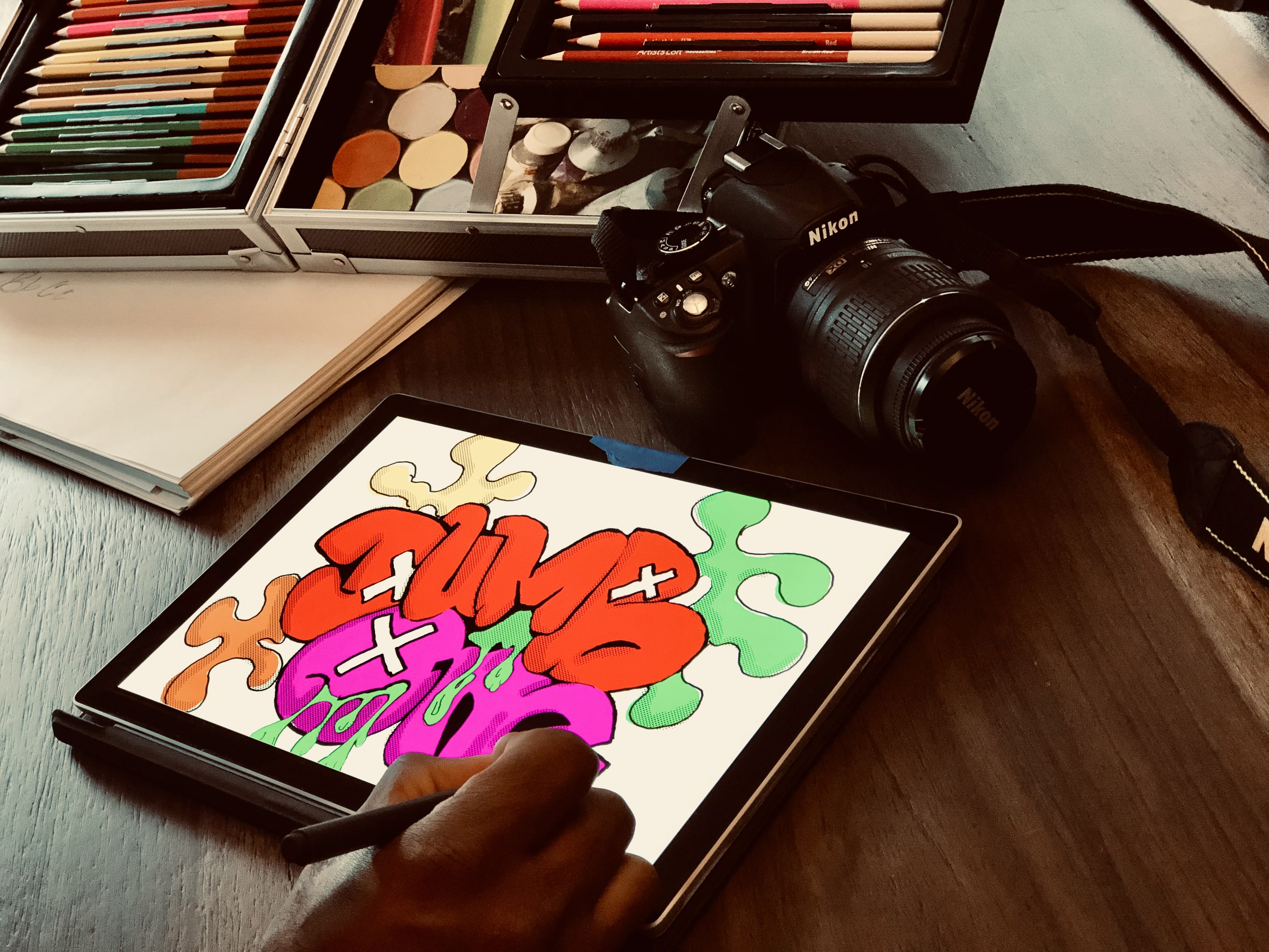 Artwork coming to life on a tablet, surrounded by pencils and studio tools